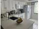 Bright kitchen featuring white cabinets, sleek countertops, and modern appliances at 210 Cypress Ct # 122, Oldsmar, FL 34677