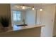 Open kitchen with bar-top seating, stainless steel faucet, and modern pendant lighting at 210 Cypress Ct # 122, Oldsmar, FL 34677