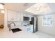 Well-lit kitchen featuring white cabinetry, stainless steel appliances, quartz countertops, and modern fixtures at 210 Cypress Ct # 122, Oldsmar, FL 34677