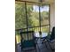 The screened lanai has an outdoor table and chairs, with scenic views of the lake at 210 Cypress Ct # 122, Oldsmar, FL 34677