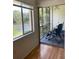 View from lanai showing seating area and lakeside views through window and screened opening at 210 Cypress Ct # 122, Oldsmar, FL 34677