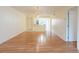 Open-concept living space featuring hardwood floors and a partial view of the kitchen at 210 Cypress Ct # 122, Oldsmar, FL 34677
