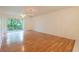 Bright living room with hardwood floors and sliding glass doors to the balcony, offering serene views at 210 Cypress Ct # 122, Oldsmar, FL 34677