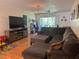 Cozy living room featuring a comfortable sectional sofa and a large TV at 210 Cypress Ct # 122, Oldsmar, FL 34677