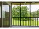 Relaxing screened patio with stunning views of lush greenery and tranquil water at 210 Cypress Ct # 122, Oldsmar, FL 34677