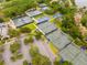 Aerial view of multiple well-maintained tennis courts, perfect for active living at 210 Cypress Ct # 122, Oldsmar, FL 34677