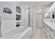 Bright bathroom features a soaking tub and walk-in shower with glass enclosure at 215 Sela Cove Cir, Apollo Beach, FL 33572