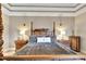 A close view of a four poster bed with exquisite wood carving details at 215 Sela Cove Cir, Apollo Beach, FL 33572