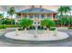 Stately community clubhouse with lush landscaping, a charming fountain, and a welcoming entrance at 215 Sela Cove Cir, Apollo Beach, FL 33572