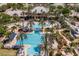 Large community pool area with water slide, lots of seating, and lush landscaping at 215 Sela Cove Cir, Apollo Beach, FL 33572