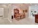 Charming dining room features a wooden table set for six, with unique lighting at 215 Sela Cove Cir, Apollo Beach, FL 33572