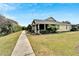 Charming home showcasing its well-maintained landscaping, walkway, and a glimpse of the neighborhood at 215 Sela Cove Cir, Apollo Beach, FL 33572
