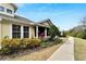 Inviting home with a screened porch, mature landscaping, and a welcoming walkway at 215 Sela Cove Cir, Apollo Beach, FL 33572