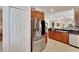 Bright kitchen area with stainless steel refrigerator and stylish tile flooring at 215 Sela Cove Cir, Apollo Beach, FL 33572