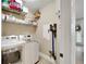 This laundry room features a washer, dryer, built-in shelves, and a hanging rack for added convenience at 215 Sela Cove Cir, Apollo Beach, FL 33572