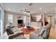 Bright living room with modern furnishings and tile flooring, seamlessly connecting to the kitchen at 215 Sela Cove Cir, Apollo Beach, FL 33572