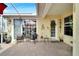 Relaxing outdoor patio featuring seating and a vibrant lemon-themed wreath, perfect for casual get-togethers and fresh air at 215 Sela Cove Cir, Apollo Beach, FL 33572