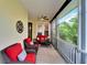 Serene screened-in porch featuring comfortable seating and views of lush greenery at 215 Sela Cove Cir, Apollo Beach, FL 33572