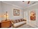 This sitting area includes a comfortable futon with decorative pillows, next to a modern lamp and chest of drawers at 215 Sela Cove Cir, Apollo Beach, FL 33572