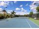 A well-maintained community tennis court on a sunny day with lush landscaping and a welcoming bench at 215 Sela Cove Cir, Apollo Beach, FL 33572