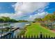 Community with a serene waterfront view, a boat dock, and beautifully manicured lawn at 215 Sela Cove Cir, Apollo Beach, FL 33572