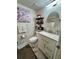 Bathroom featuring updated vanity, modern fixtures, and marble floors, combining functionality with a touch of elegance at 220 Cypress Ln # 220, Oldsmar, FL 34677
