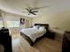 Cozy bedroom with a ceiling fan and a large window at 220 Cypress Ln # 220, Oldsmar, FL 34677