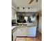 Open concept kitchen with granite countertops and a view into the living area at 220 Cypress Ln # 220, Oldsmar, FL 34677