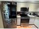 Modern kitchen with stainless steel appliances and ample white cabinetry at 220 Cypress Ln # 220, Oldsmar, FL 34677