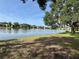 Scenic lake view with mature trees and waterfront condos in the background at 220 Cypress Ln # 220, Oldsmar, FL 34677