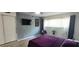 Stylish bedroom featuring a modern gray accent wall, a flat-screen TV, and a comfortable bed, creating a chic retreat at 2261 Swedish Dr # 59, Clearwater, FL 33763