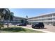 Well-maintained condominium building with a clock tower, ample parking, and lush landscaping at 2261 Swedish Dr # 59, Clearwater, FL 33763