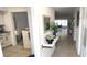 Inviting hallway with neutral tones and stylish decor leading to the bright living area at 2261 Swedish Dr # 59, Clearwater, FL 33763