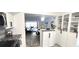 Eat-in kitchen with stainless steel appliances and white cabinets open to the living area at 2261 Swedish Dr # 59, Clearwater, FL 33763