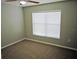 Cozy bedroom with neutral carpet, a window with blinds, and ample natural light at 24741 Ravello St, Land O Lakes, FL 34639