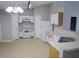 Bright kitchen featuring white appliances, ample cabinet space, and a double stainless steel sink at 24741 Ravello St, Land O Lakes, FL 34639