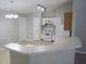 Open kitchen with white cabinets, modern appliances, and a breakfast bar overlooking the living area at 24741 Ravello St, Land O Lakes, FL 34639