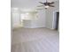 Spacious living room with neutral carpet, ceiling fan, and an open layout to the kitchen area at 24741 Ravello St, Land O Lakes, FL 34639