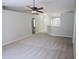 Inviting living room featuring a ceiling fan and neutral carpet, with an open layout at 24741 Ravello St, Land O Lakes, FL 34639