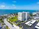 An aerial view of a condo building, displaying its proximity to the water and well-maintained surroundings on a sunny day at 2530 Gary Cir # 301, Dunedin, FL 34698