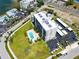 Overhead view showcasing the community's pool, lush green spaces, parking, and the overall layout of the condo building at 2530 Gary Cir # 301, Dunedin, FL 34698