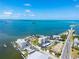 Wide aerial view of waterfront condos, a marina, and beautiful blue water at 2530 Gary Cir # 301, Dunedin, FL 34698