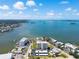 A scenic aerial view showcasing the community's waterfront location, buildings, pool, and lush landscaping at 2530 Gary Cir # 301, Dunedin, FL 34698