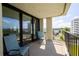 Relaxing balcony with seating overlooking the bay with views of neighboring high-rise buildings at 2530 Gary Cir # 301, Dunedin, FL 34698