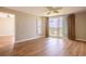 Bright bedroom with wood floors, ceiling fan, and sliding glass doors to a balcony at 2530 Gary Cir # 301, Dunedin, FL 34698
