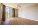 Bright bedroom with wood flooring and access to a private balcony with views at 2530 Gary Cir # 301, Dunedin, FL 34698