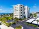Exterior shot of the Marina Tower condos with a well maintained lawn and parking area at 2530 Gary Cir # 301, Dunedin, FL 34698