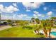 Scenic view from balcony featuring water views, lush green grass, and mature palm trees at 2530 Gary Cir # 301, Dunedin, FL 34698
