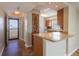 Kitchenette with a granite countertop, brown cabinets, and stainless steel appliances at 2530 Gary Cir # 301, Dunedin, FL 34698