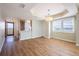 Open-concept living space featuring wood floors and abundant natural light at 2530 Gary Cir # 301, Dunedin, FL 34698